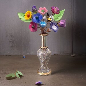 Glass flower bouquet lamp with colorful lampwork blooms in a gold-tinted vase