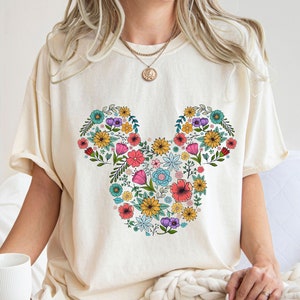 Cream T-shirt with colorful floral Mickey graphic on the front
