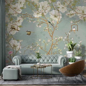Floral wallpaper mural with pastel blossoms, birds, and hanging lanterns on branches.