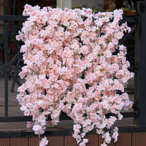 Artificial cherry blossom garland with pink and white blossoms, hanging vine decoration