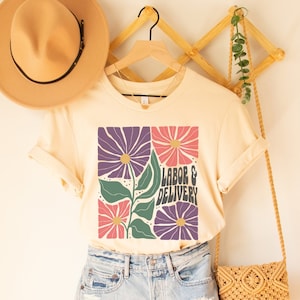 Cream floral labor & delivery T-shirt with bold graphic and text front