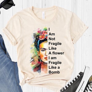 Cream graphic T-shirt with Frida portrait and 'not fragile like a flower' slogan