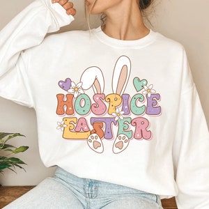 White T-shirt with 'Hospice Easter' bunny and paw print graphic