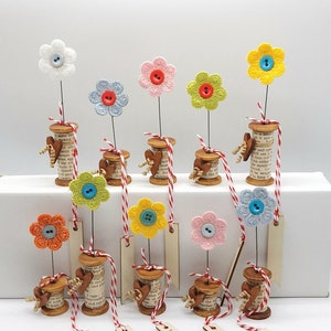 Set of handmade cotton reel flower arrangements with colorful fabric button blooms and love tags