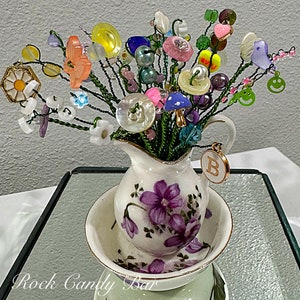 Mini beaded flower bouquet in white ceramic dish, with purple and green flowers