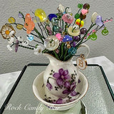 Mini beaded flower bouquet in white ceramic dish, with purple and green flowers