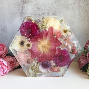 Preserved wedding bouquet in clear resin tray with pink and white dried blooms