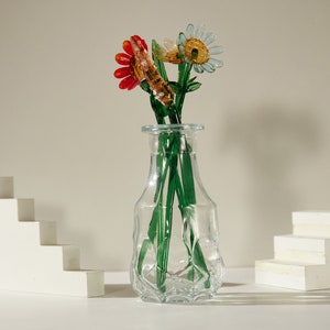 Glass flower garden stake figurine with red and yellow blossoms on green stem
