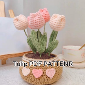 Crochet tulip flowerpot pattern with pink crocheted tulips, green leaves, beige pot