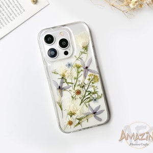 Clear white flower phone case with pressed botanicals and raised camera cutouts