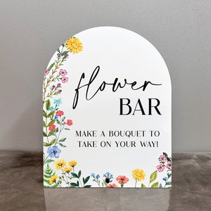 Arched acrylic sign with floral border, text 'Flower BAR' and quote at bottom
