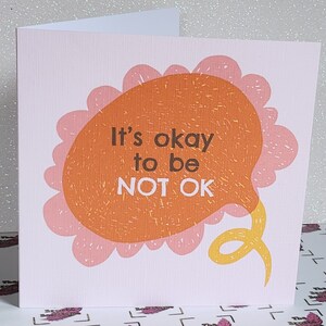 Handmade mental health affirmation card with pale pink flower and “It’s okay to be NOT OK”