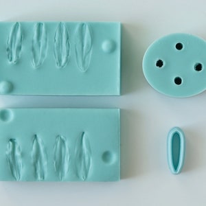Teal silicone petal veiner flower press mold with flower and leaf texture cavities