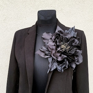 Oversized black fabric flower brooch pin corsage on jacket lapel
