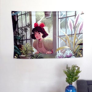 Wall tapestry with cartoon girl wearing a red hat, framed by plants and windows