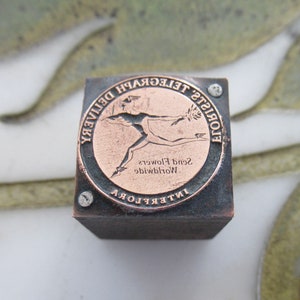 Antique square letterpress printing block with FTD florists telegraph emblem