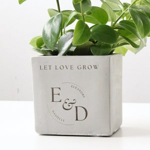 Personalized engraved planter pot with 'Let Love Grow' and initials 'E & D'
