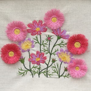 Fluffy fringe flower embroidery design with pink and purple blooms on a stem