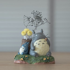 Studio Ghibli Totoro-themed resin figurine with two characters and flowers on base