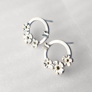 Silver hoop stud earrings with flower and butterfly charms