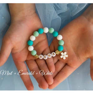 Kids beaded bracelet with flower charm and mint, green, and white beads