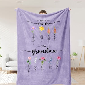 Lavender birth-flower blanket with floral text 'First mom now grandma' and names