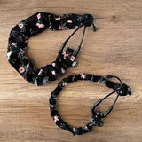Black floral scrunchie set with pink and white rose pattern, elastic bow ties