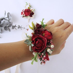 Red rose floral wrist corsage bracelet with ribbon and small white blooms