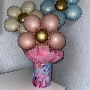 Balloon bouquet gift with metallic pink, gold, and blue balloons in floral wrap