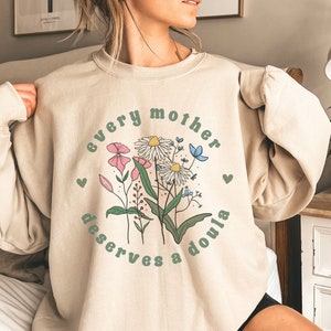 Cream doula shirt with puff sleeves, floral hearts graphic, 'Every mother deserves a doula'