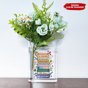 Book-shaped acrylic vase holding white and green flowers, printed cover front