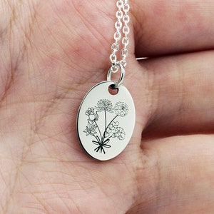 Oval silver birth-flower pendant necklace with engraved floral bouquet on plate
