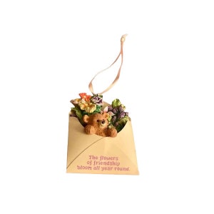 Hanging teddy bear Christmas tree ornament with flowers and cream gift tag