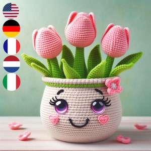 Crochet tulip plant in a white pot, with three pink tulip flowers and green leaves