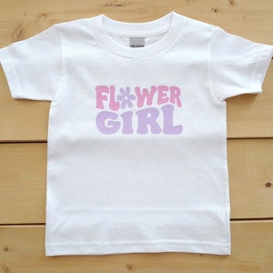 White T-shirt with pastel 'Flower Girl' graphic lettering, short sleeves
