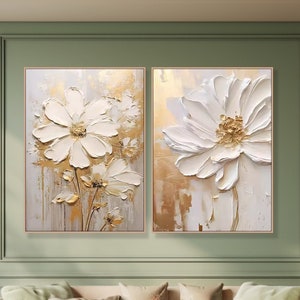 Set of 2 framed cream canvas floral paintings with white petals and gold accents
