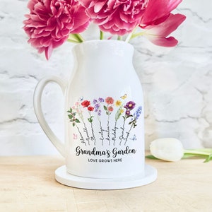 White ceramic flower vase with handle, floral print and “Grandma’s Garden” text