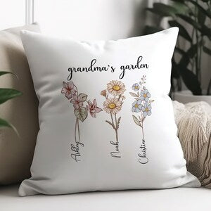 White garden throw pillow with illustrated flowers and cursive birthflower names