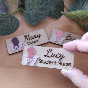 Wooden engraved baby tag ID badge with name text Mary, Lucy, and pink heart details