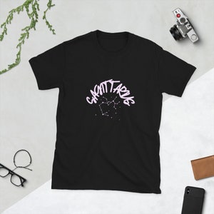 Black unisex T-shirt with white zodiac-themed graphic print, short sleeves