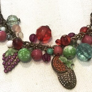 Multicolor glass bead necklace with fruit and flower charm drops and dark metal links