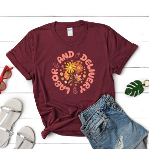 Unisex t-shirt in dark maroon with colorful flower and circular graphic print