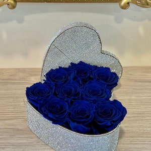 Heart-shaped silver crystal box with dark blue preserved roses