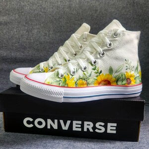 White high-top Converse sneakers with sunflower floral fan art on side and toe