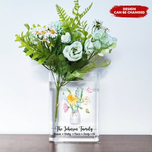 Book-shaped acrylic flower vase with floral print and white-green artificial bouquet