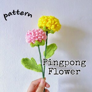 Crochet pingpong flower bouquet: yellow and pink blooms with green leaves in hand