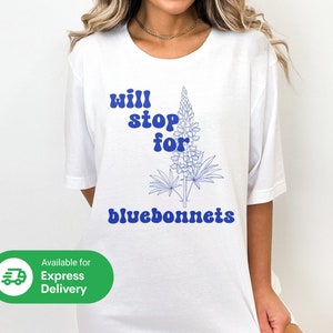 White graphic T-shirt with blue text "Will stop for Bluebonnets" and wildflower