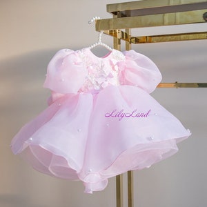 Pink tulle flower girl dress with layered skirt and bow bodice detail