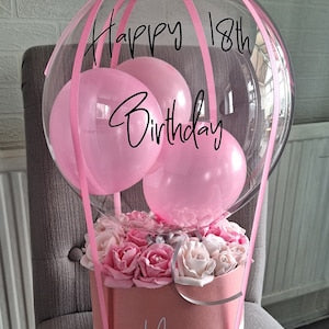 Pink hot air balloon flower box with balloons, pink/white roses, and 'Happy 18th Birthday'.