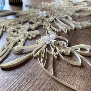White turned-paper floral centerpiece with curled rosette flowers